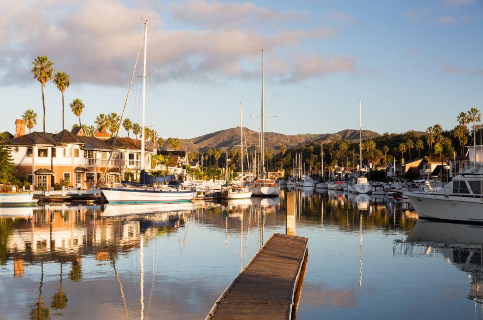 Residential development by water in Ventura California with modern homes and yachts boats; 