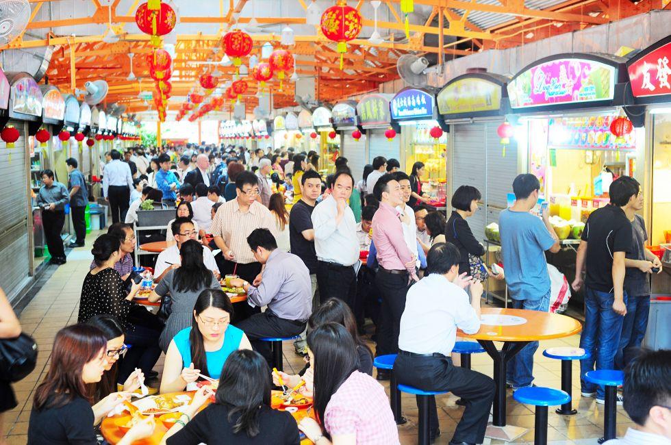 Singapore, Republic of Singapore - March 06, 2013: Locals eat at a popular food hall in Singapore. Inexpensive food stalls are numerous in the city so most Singaporeans dine out at least once a day.