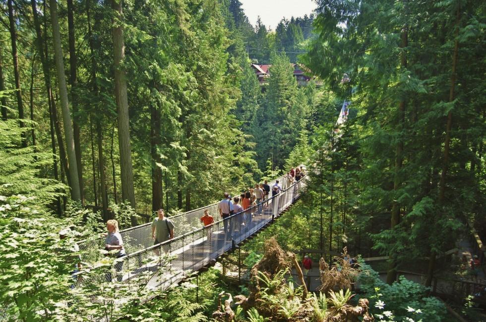 VANCOUVER - JULY 05: People at Capilano Bridge on July 05, 2008 in Vancouver Canada. Suspension bridge crossing the Capilano River, and it is 140 metres long and 70 metres above the river.; 