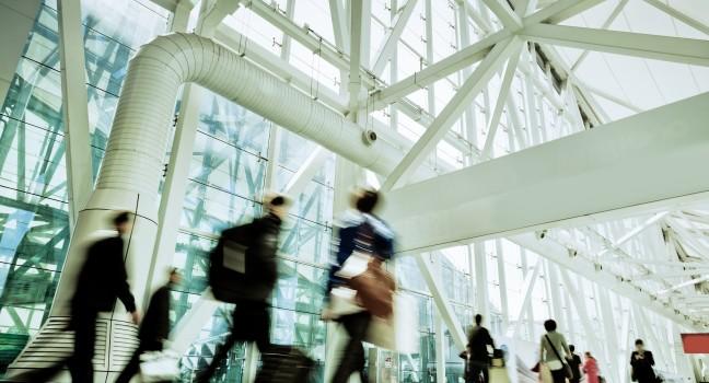 Futuristic Guangzhou Airport interior people walking in motion blur.