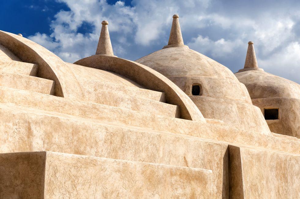 Jami al-Hamoda Mosque located in the town of Jalan Bani Bu Ali, Sultanate of Oman with its unique structure of 52 domes and a falaj used for ablutions running through the courtyard.
