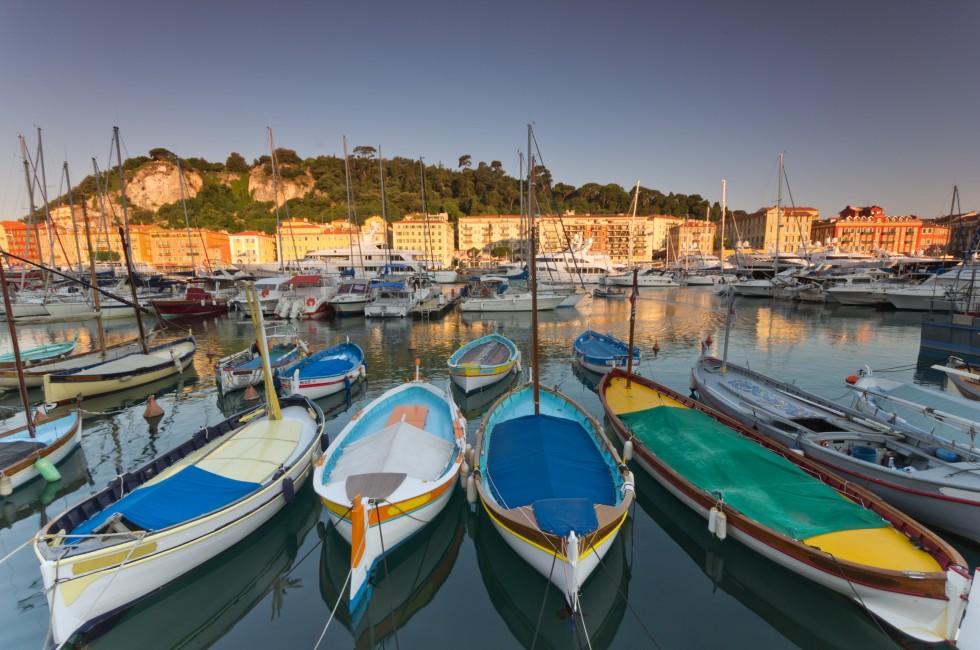 Old classic wooden boats and luxury yachts rest in the old port of Nice , cote azur, France.