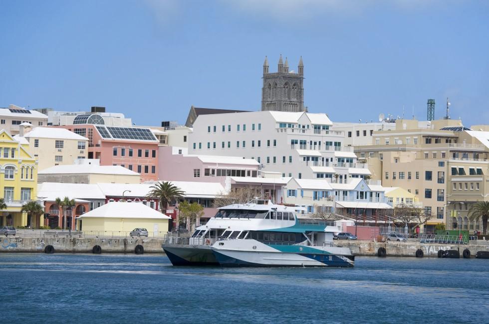 A Bermuda ferry cruising past the downtown waterfront of Hamilton, Bermuda.;