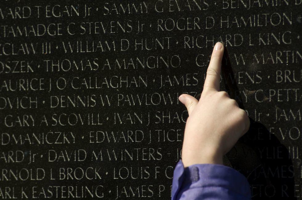 a finger points out a name inscribed at the Vietnam Veterans Memorial in Washington, DC; Shutterstock ID 10795432; Project/Title: Fodors; Downloader: Melanie Marin