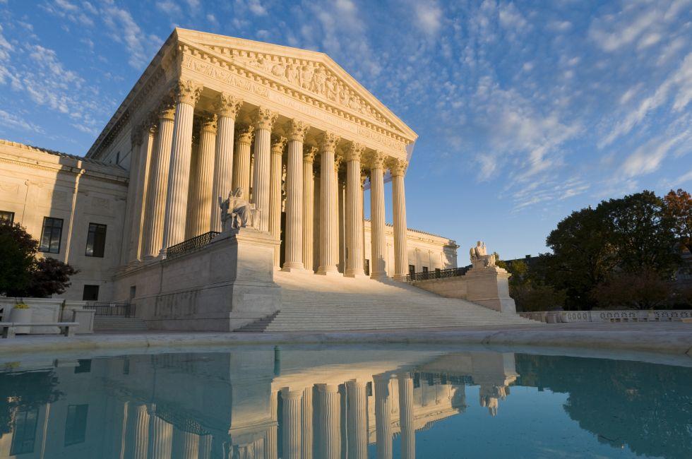 The front of the US Supreme Court in Washington, DC, at dusk.