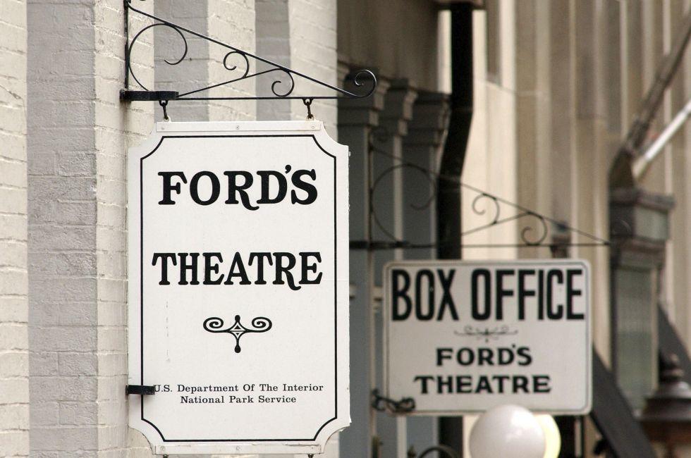 WASHINGTON - JUNE 9:  Signs hang on the front of Ford's Theater June 9, 2003 in Washington, DC. U.S. President Abraham Lincoln was shot inside the theater by John Wilkes Booth April 14, 1865 and died the next morning in a house across the street. Confedera