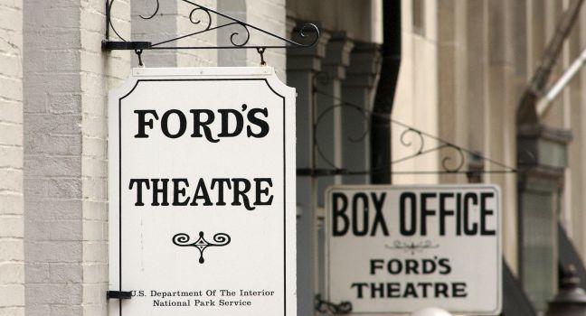 WASHINGTON - JUNE 9:  Signs hang on the front of Ford's Theater June 9, 2003 in Washington, DC. U.S. President Abraham Lincoln was shot inside the theater by John Wilkes Booth April 14, 1865 and died the next morning in a house across the street. Confedera