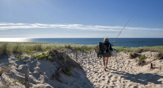 CAPE COD, MA - JUNE 19: A woman goes fishing at Race Point Beach on June 19, 2010 in Cape Cod. Cape Cod was the historic landing of Mayflower and is today a major travel destination in Massachusetts.