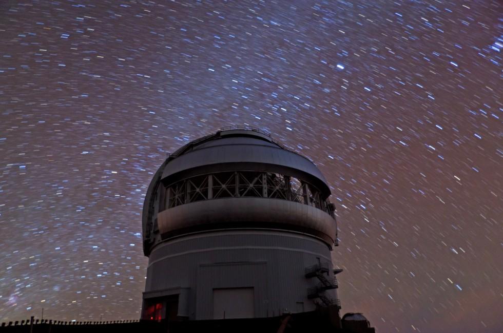 Star observatory in Hawaii at night with Milky Way.