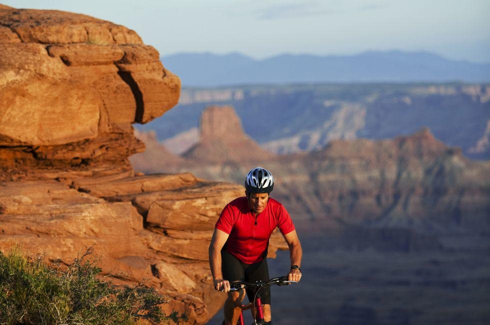 Male bicyclist mountain biking in Canyonlands.