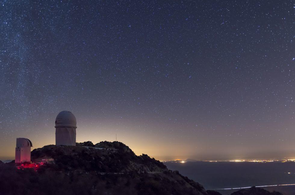 The Mayall observatory at Kitt Peak overlooks Tucson, Arizona on a clear starry night