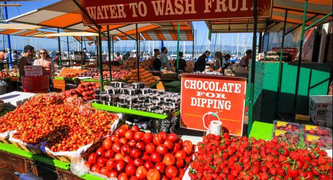 Summer crowds check out the fresh fruit and other items available at the Farmer's Market on Pier 39, located at the edge of famous Fisherman&#x2019;s Wharf and the Embarcadero along San Francisco&#x2019;s historic waterfront. Hugely popular, it is one of t