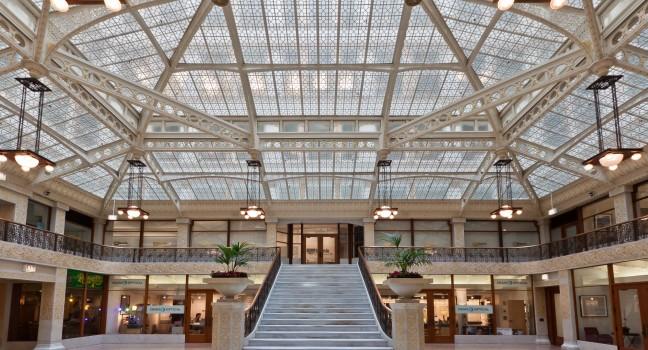 The main lobby of the Rookery building with its glass ceiling and amazing stairs. Chicago downtown, Illinois, United States.