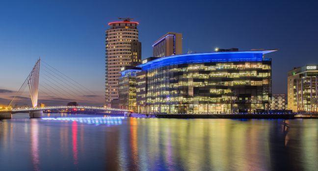 Manchester, UK - March 14, 2015: Salford Quays, Manchester. Night view of the BBC and ITV studio complex at Media City, Salford.