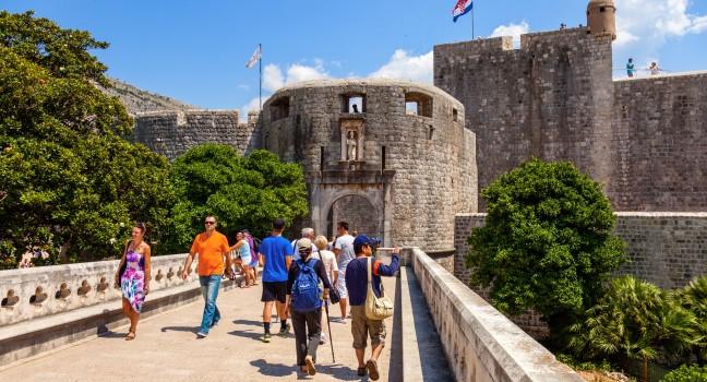 DUBROVNIK, CROATIA - JULY 19: Unknown tourists near at the Pile Gate, on July 19, 2014 in Dubrovnik, Croatia. The Pile Gate is one of the entrance through the wall of the historic center of Dubrovnik.