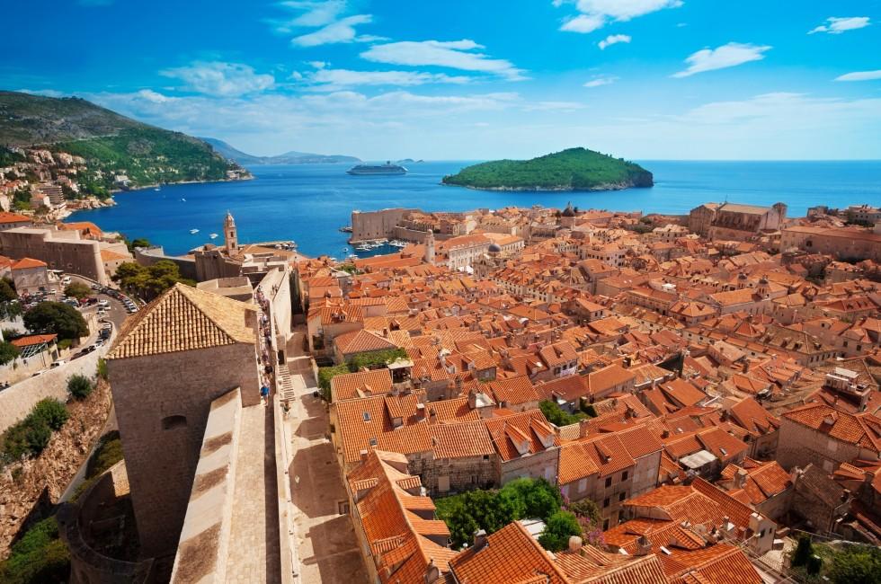 Old town of Dubrovnik with Lokrum island on background with red roofs