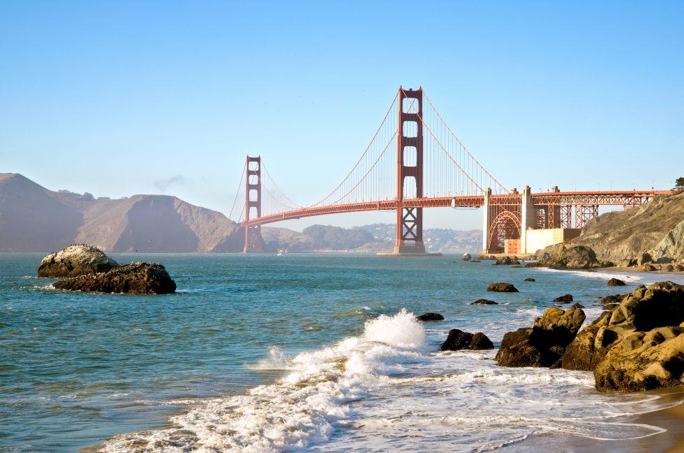 San Francisco Golden Gate Bridge from Baker Beach with pacific Ocean surf and waves.
