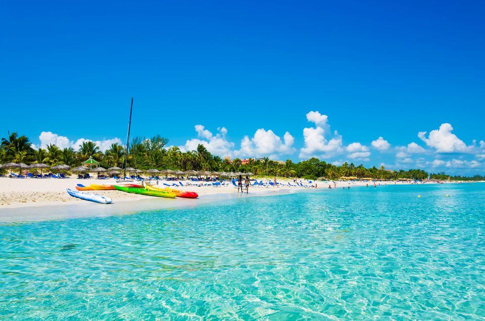 The beautiful beach of Varadero in Cuba with colorful boats and thatched umbrellas (image taken from the sea).