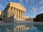 The front of the US Supreme Court in Washington, DC, at dusk.