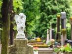 A white mourning porcelain angel on a cross in Mirogoj cemetery, Zagreb, Croatia.