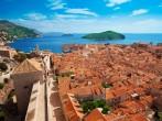 Old town of Dubrovnik with Lokrum island on background with red roofs