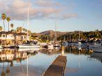 Residential development by water in Ventura California with modern homes and yachts boats; 