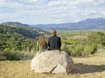 Couple sits and meditates at Meditation Mount's Point overlooking the Ojai Valley, CA