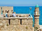 JAFFA, ISRAEL - APR 11, 2014: People eating breakfast with views of the Mediterranean in Jaffa, Tel Aviv, Israel