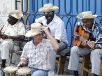 Cuban street musicians sitting in the cathedral square, performing for the tourists with traditional Cuban music. 
