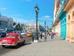 Street scene with people and traffic on a beautiful sunny day in Old Havana.