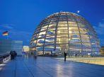 Illuminated glass dome on the roof of the Reichstag in Berlin in the evening; 