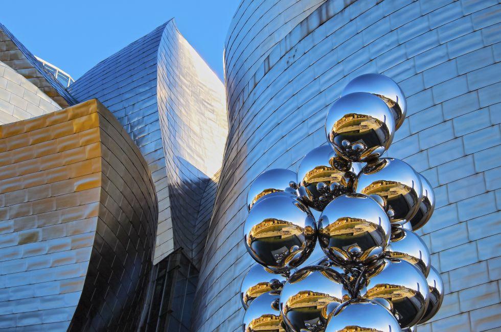 BILBAO, SPAIN - MARCH 9, 2013: Sculpture &quot;The Big Tree&quot; consisting of 80 stainless steel balls with reflections by Anish Kapoor in front of The Guggenheim Museum in Bilbao, Basque Country, Spain