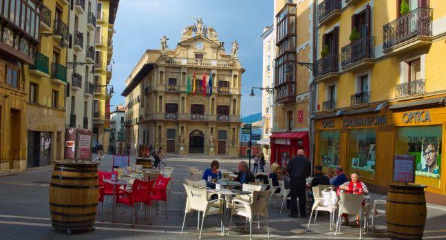 PAMPLONA, SPAIN, OCTOBER 25, 2014: People are having lunch in a restaurant in front of the town hall in spanish city pamplona.