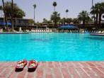 Sandals Next To Large Empty Swimming Pool In Palm Springs, California; 