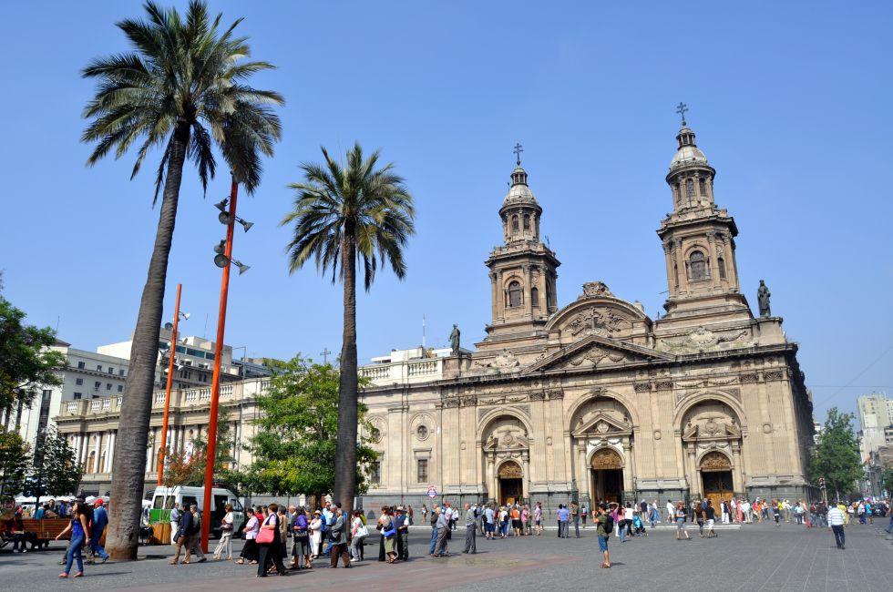 SANTIAGO - FEBRUARY 1, 2012: Summer brings tourists to downtown Santiago. Visitors gather in front of the Santiago Cathedral at Plaza de Armas in the city historic center on February 1, 2013.