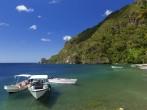 Boats on the clear waters of a beach in Soufriere in St Lucia;  