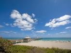 A dock goes far out into the water in Palm Beach, Florida.;
