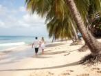 Couple walking by the sea in Barbados 