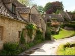 Traditional Cotswold cottages in England, UK.  after the rain. spring. Bibury is a village and civil parish in Gloucestershire, England.