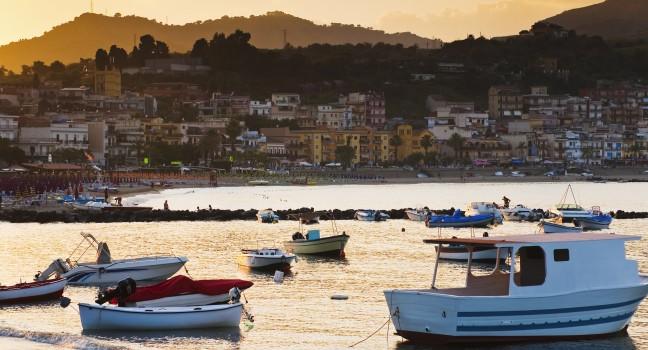 boats at sunset, near town Taormina, Sicily, Italy 