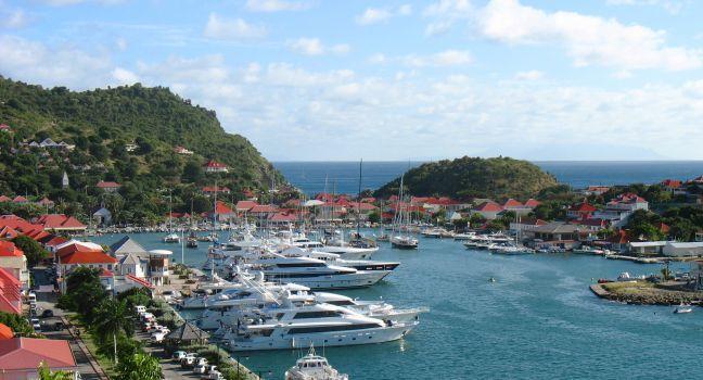 ST BARTS, FRENCH WEST INDIES - JANUARY 16:Aerial view at Gustavia Harbor with mega yachts on January 16, 2006 at St Barts. The island is popular tourist destination during the winter holiday season 