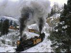 On a wintry curve of iron rails, coal-fired engines cough plumes of smoke and tug their locomotive burden across the Rocky Mountains, Train, Durango, Colorado