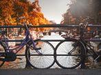 Two bikes on a bridge over a canal in Jordaan, Amsterdam, Netherlands