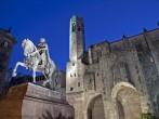 Ramon Berenguer El Gran Square with the statue of the king Ramon Berenguer III, the medieval city walls and Santa Agata Chapel with its bell tower. Barcelona. Catalonia, Spain.