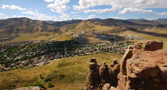 Nestled between the Rocky Mountains, Golden, Colorado stretches under a blue sky.