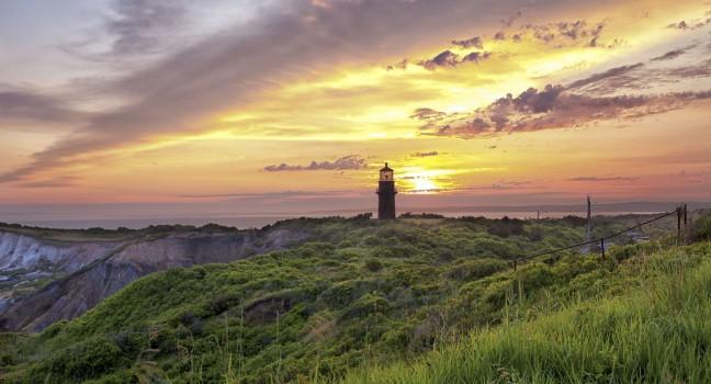 View of a lighthouse with colorful sky n the background.