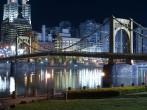 Riverfront park with graceful bridge in Pittsburgh Pennsylvania.; 
