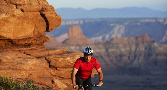 Male bicyclist mountain biking in Canyonlands.