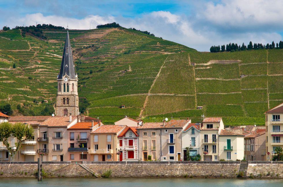 A riverside Village and Vineyards on the Hills of the Cote du Rhone Area in France.