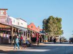 Looking down Allen Street in historic Tombstone, Arizona with cowboys and tourists.